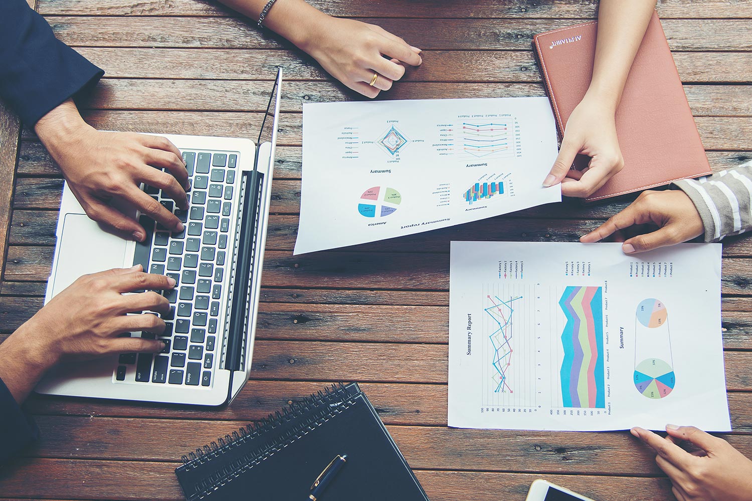 Strategic planning workspace with documents and laptop